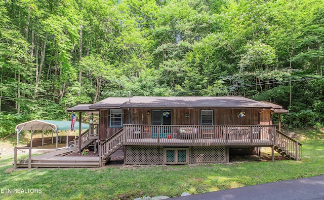 305 Shields View Dr, Gatlinburg, TN 37738 - view of front of home featuring a detached carport, stairs, a view of trees, and a front lawn