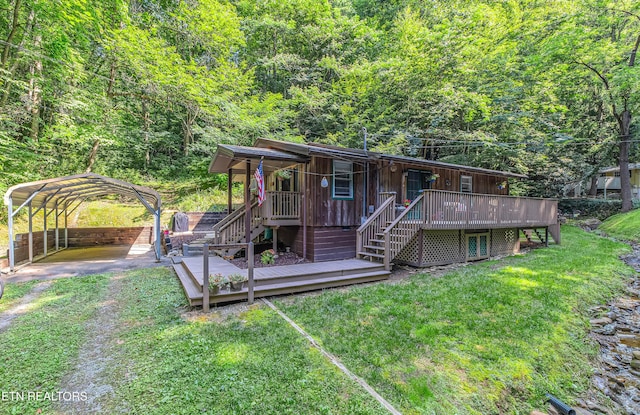 305 Shields View Dr, Gatlinburg, TN 37738 - back of property with stairs, a detached carport, a forest view, and a lawn