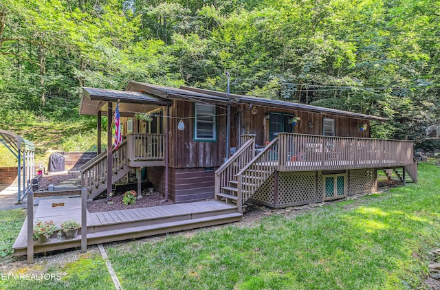 305 Shields View Dr, Gatlinburg, TN 37738 - view of front of property with stairs, a front lawn, a wooden deck, and a wooded view