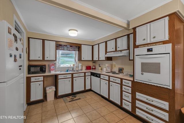 305 Shields View Dr, Gatlinburg, TN 37738 - kitchen with crown molding, white appliances, light countertops, light tile patterned flooring, and under cabinet range hood