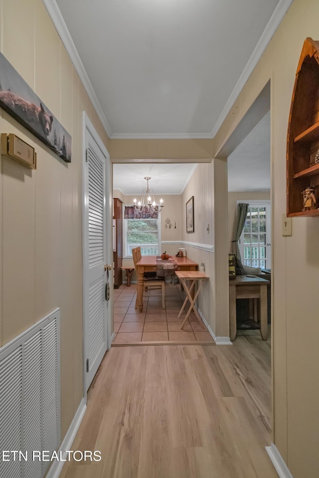 305 Shields View Dr, Gatlinburg, TN 37738 - hall featuring light wood-style flooring, crown molding, a chandelier, plenty of natural light, and a decorative wall