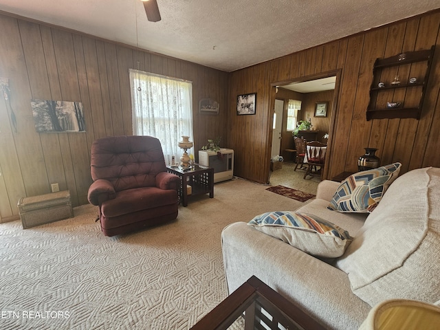1106 Smyth Chapel Rd, Pennington Gap, VA 24277 - carpeted living room with ceiling fan, wood walls, and a textured ceiling
