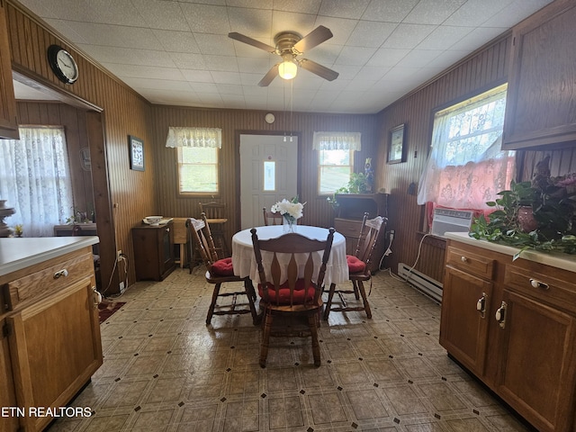 1106 Smyth Chapel Rd, Pennington Gap, VA 24277 - dining space featuring healthy amount of natural light, tile patterned floors, a ceiling fan, and wood walls