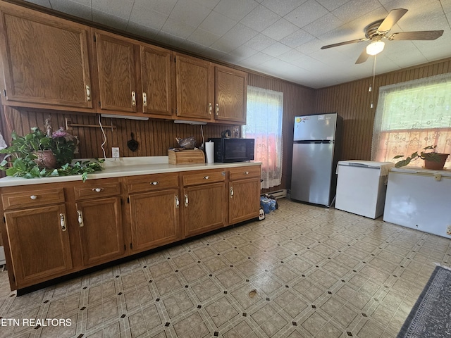 1106 Smyth Chapel Rd, Pennington Gap, VA 24277 - kitchen with freestanding refrigerator, black microwave, white refrigerator, light countertops, and ceiling fan