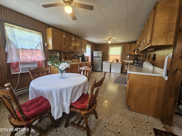 1106 Smyth Chapel Rd, Pennington Gap, VA 24277 - dining area with ceiling fan, light floors, cooling unit, and wood walls