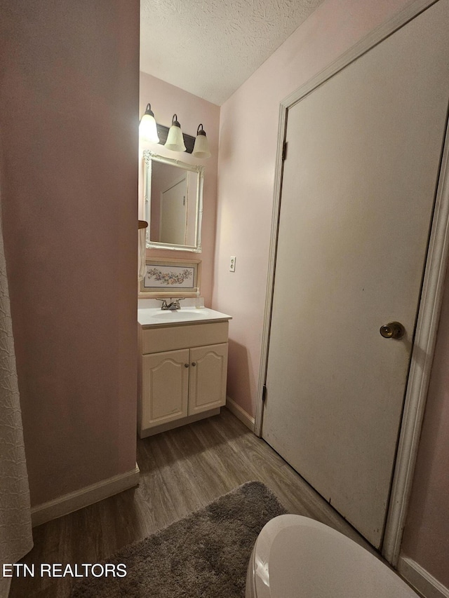 1106 Smyth Chapel Rd, Pennington Gap, VA 24277 - bathroom featuring wood finished floors, vanity, and a textured ceiling