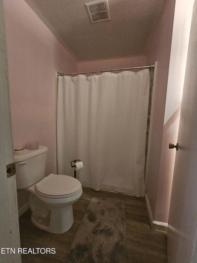 1106 Smyth Chapel Rd, Pennington Gap, VA 24277 - full bathroom with wood finished floors, a textured ceiling, and curtained shower