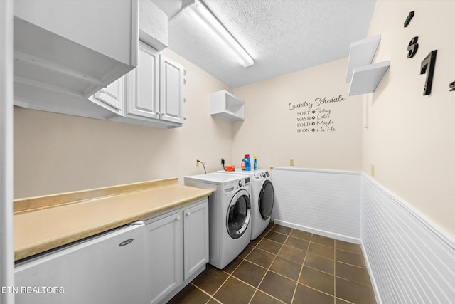 1476 Pheasants Glen Dr, Knoxville, TN 37923 - washroom featuring washing machine and dryer, a wainscoted wall, cabinet space, dark tile patterned floors, and a textured ceiling