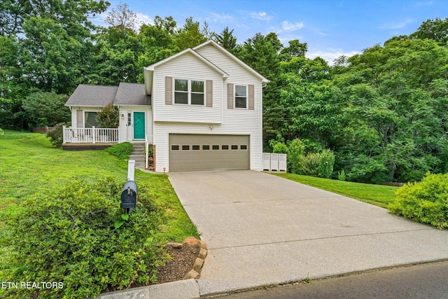 1476 Pheasants Glen Dr, Knoxville, TN 37923 - tri-level home featuring an attached garage, a front lawn, driveway, and view of wooded area