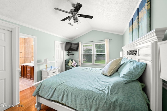 1476 Pheasants Glen Dr, Knoxville, TN 37923 - bedroom with wood finished floors, vaulted ceiling, a textured ceiling, crown molding, and connected bathroom