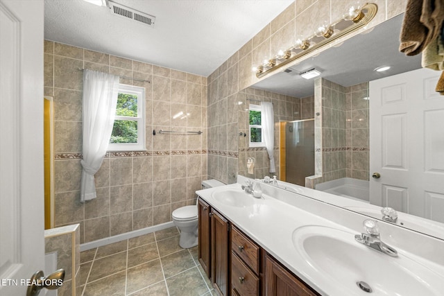 1476 Pheasants Glen Dr, Knoxville, TN 37923 - full bathroom with a shower stall, healthy amount of natural light, a bath, double vanity, and tile walls