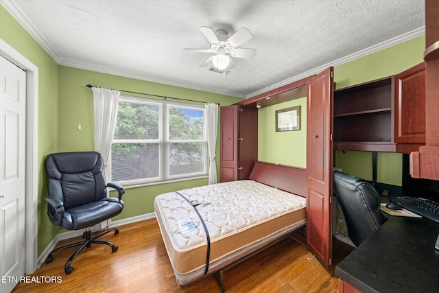 1476 Pheasants Glen Dr, Knoxville, TN 37923 - bedroom featuring wood finished floors, crown molding, a desk, a textured ceiling, and a ceiling fan