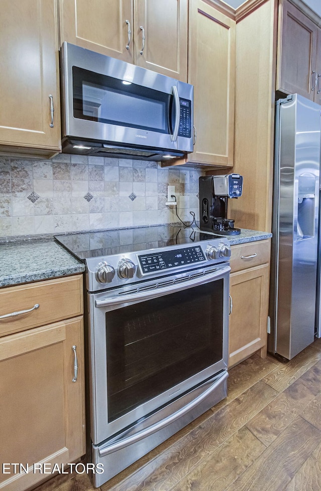 12504 Tangle Crest Ln, Knoxville, TN 37932 - kitchen featuring appliances with stainless steel finishes, tasteful backsplash, and light stone countertops
