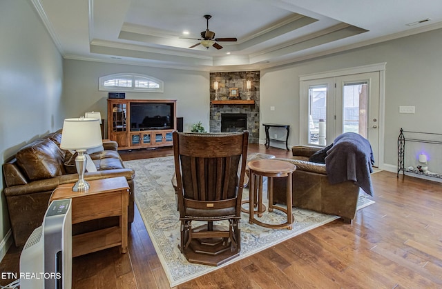 12504 Tangle Crest Ln, Knoxville, TN 37932 - living room featuring a tray ceiling, ceiling fan, healthy amount of natural light, wood finished floors, and ornamental molding