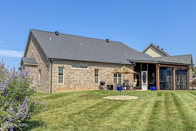 12504 Tangle Crest Ln, Knoxville, TN 37932 - rear view of property with brick siding, a lawn, a sunroom, and a shingled roof