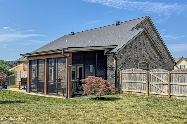 12504 Tangle Crest Ln, Knoxville, TN 37932 - back of property with a gate, a sunroom, brick siding, a patio, and a shingled roof