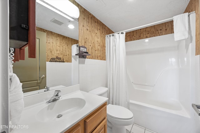 818 Golf View Blvd Unit 1502, Pigeon Forge, TN 37863 - bathroom with vanity, shower / tub combo with curtain, tile patterned floors, wooden walls, and tile walls