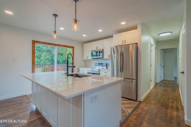 213 Towne Rd, Knoxville, TN 37934 - kitchen with stainless steel appliances, white cabinets, a kitchen island with sink, hanging light fixtures, and recessed lighting