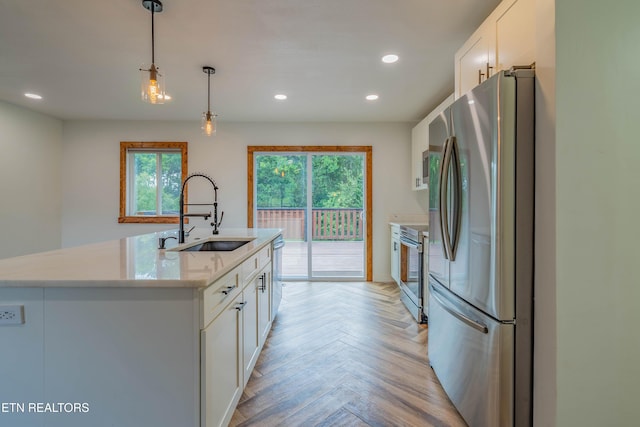 213 Towne Rd, Knoxville, TN 37934 - kitchen with appliances with stainless steel finishes, white cabinetry, pendant lighting, recessed lighting, and an island with sink
