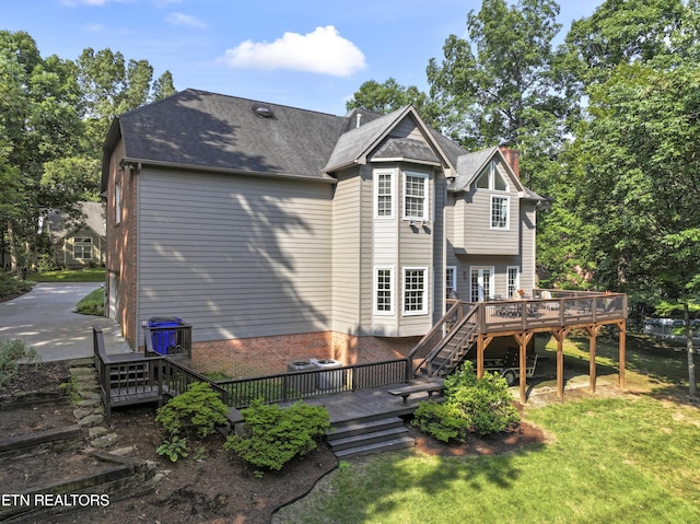 11424 Gates Mill Dr, Knoxville, TN 37934 - back of property with stairway, a wooden deck, a chimney, and a lawn
