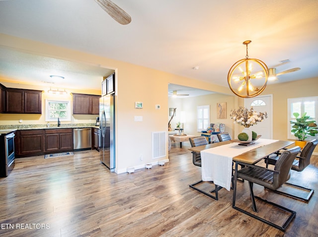 4139 Browder Hollow Rd, Lenoir City, TN 37771 - dining space with ceiling fan, light wood-style flooring, healthy amount of natural light, and a chandelier