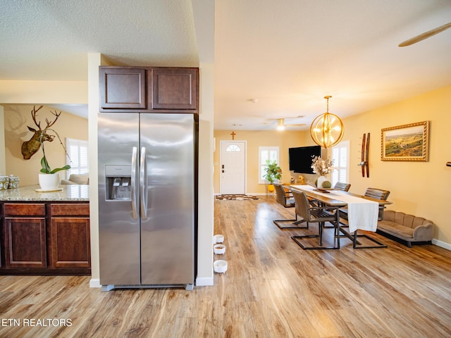 4139 Browder Hollow Rd, Lenoir City, TN 37771 - kitchen with stainless steel fridge, light wood-style floors, dark brown cabinets, open floor plan, and a chandelier