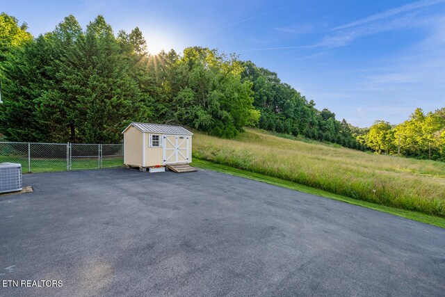 505 Bugaboo Springs Rd, Jonesborough, TN 37659 - view of patio / terrace featuring a storage unit and a wooded view