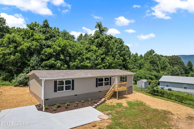308 Cowan Ln, Lafollette, TN 37766 - view of front of property with crawl space, stairway, a wooded view, and a front yard