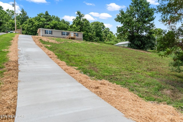 308 Cowan Ln, Lafollette, TN 37766 - view of grassy yard featuring concrete driveway