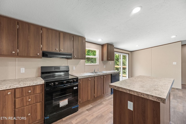 308 Cowan Ln, Lafollette, TN 37766 - kitchen with black appliances, under cabinet range hood, light wood-style flooring, light countertops, and a textured ceiling