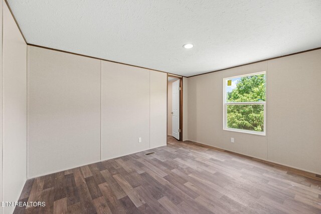 308 Cowan Ln, Lafollette, TN 37766 - unfurnished bedroom featuring wood finished floors, a textured ceiling, and recessed lighting