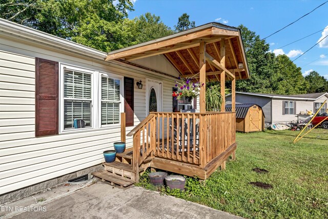 125 Loggers Ln, Clinton, TN 37716 - wooden terrace with a yard and a storage unit
