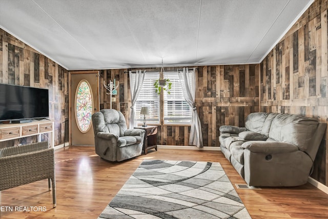 125 Loggers Ln, Clinton, TN 37716 - living area with wood walls, wood finished floors, and a textured ceiling