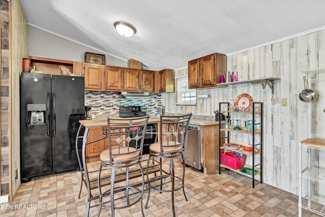 125 Loggers Ln, Clinton, TN 37716 - kitchen featuring black appliances, brick patterned flooring, brown cabinetry, vaulted ceiling, and tasteful backsplash