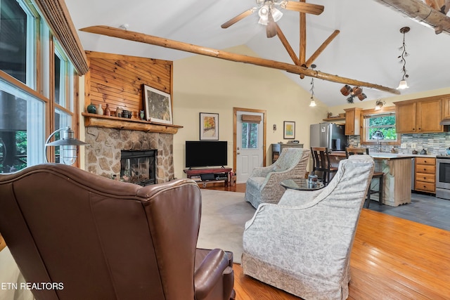 132 Cutter Gap Rd, Townsend, TN 37882 - living room featuring a stone fireplace, high vaulted ceiling, ceiling fan, and wood finished floors