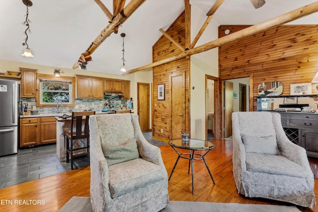 132 Cutter Gap Rd, Townsend, TN 37882 - living room featuring dark wood-style floors, wooden walls, rail lighting, high vaulted ceiling, and beamed ceiling