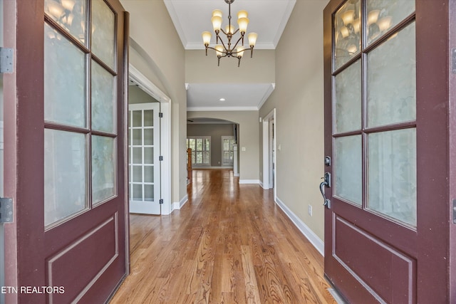 1219 Barton Place Ln, Knoxville, TN 37922 - foyer featuring ornamental molding, light wood finished floors, a chandelier, and arched walkways