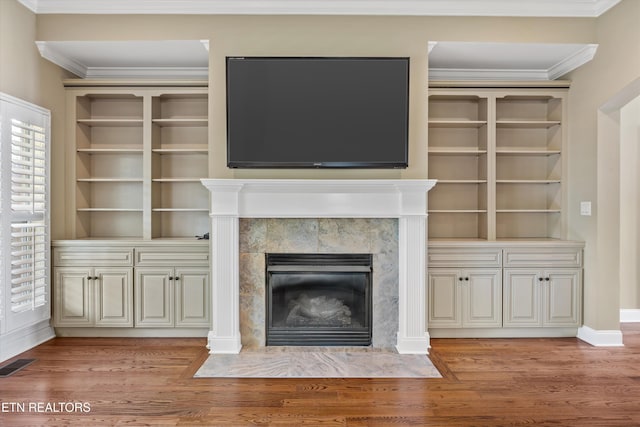 1219 Barton Place Ln, Knoxville, TN 37922 - unfurnished living room with light wood-type flooring, a fireplace, crown molding, and built in shelves