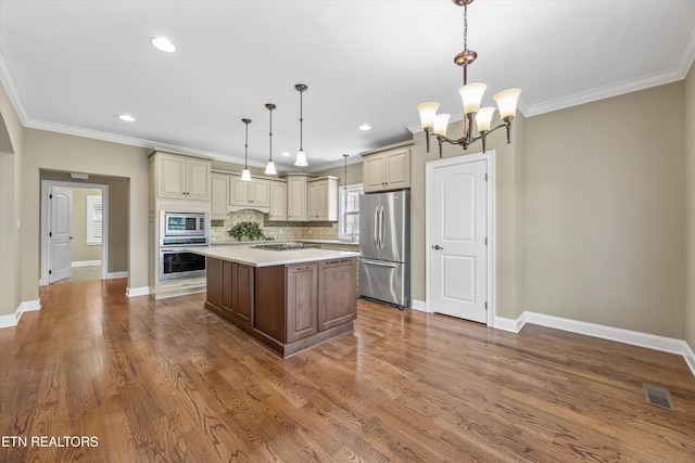 1219 Barton Place Ln, Knoxville, TN 37922 - kitchen with stainless steel appliances, cream cabinets, light countertops, a chandelier, and a kitchen island