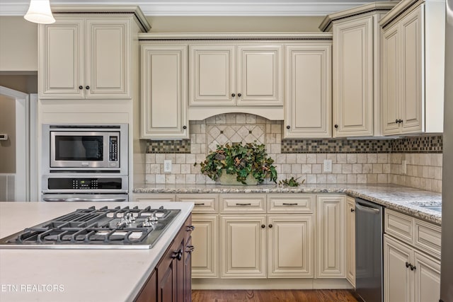 1219 Barton Place Ln, Knoxville, TN 37922 - kitchen featuring appliances with stainless steel finishes, cream cabinetry, backsplash, and light stone countertops
