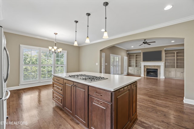 1219 Barton Place Ln, Knoxville, TN 37922 - kitchen featuring appliances with stainless steel finishes, a ceiling fan, arched walkways, crown molding, and light countertops