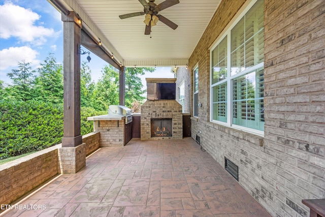 1219 Barton Place Ln, Knoxville, TN 37922 - view of patio / terrace with an outdoor stone fireplace, ceiling fan, and exterior kitchen