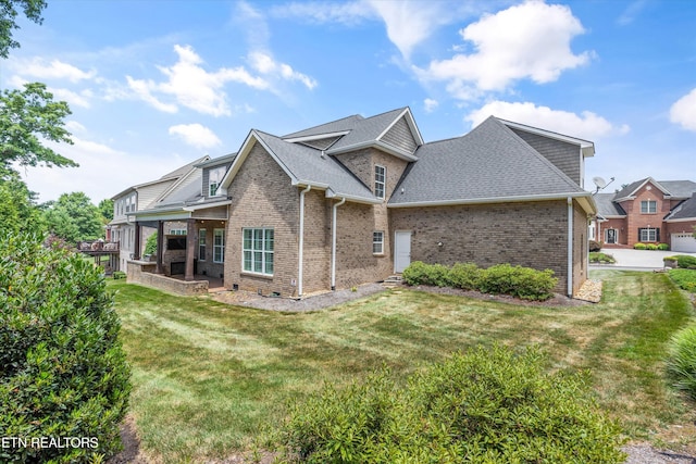 1219 Barton Place Ln, Knoxville, TN 37922 - view of property exterior with brick siding, a yard, and a shingled roof