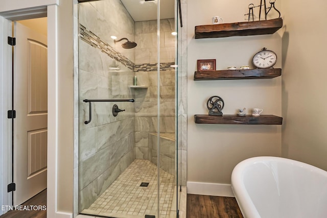 265 Falling Leaf Rd, Jamestown, TN 38556 - bathroom featuring a freestanding bath, wood finished floors, and a stall shower