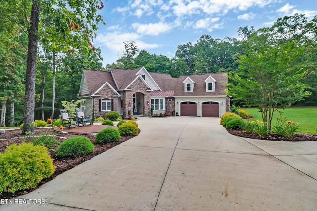 265 Falling Leaf Rd, Jamestown, TN 38556 - craftsman-style house with driveway, a garage, and stone siding