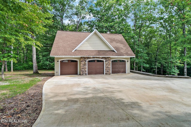 265 Falling Leaf Rd, Jamestown, TN 38556 - garage with concrete driveway and view of wooded area