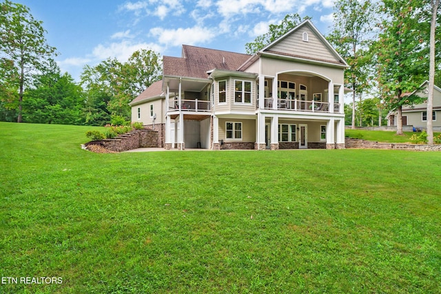 265 Falling Leaf Rd, Jamestown, TN 38556 - back of house featuring a balcony, a lawn, and a shingled roof