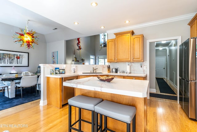 1155 Evelyn Mae Way, Knoxville, TN 37923 - kitchen with appliances with stainless steel finishes, a peninsula, light wood-style floors, a breakfast bar, and a kitchen island