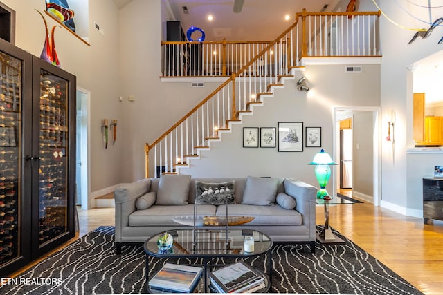 1155 Evelyn Mae Way, Knoxville, TN 37923 - living area featuring a towering ceiling, stairs, and wood finished floors