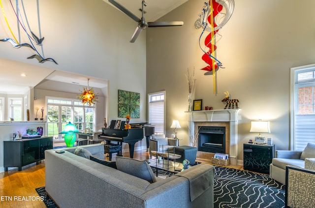 1155 Evelyn Mae Way, Knoxville, TN 37923 - living area featuring a fireplace, ceiling fan, crown molding, wood finished floors, and a towering ceiling